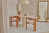 Aime Té Tribute dining chair with upholstered off-white seat and black legs, modern design and comfortable seating.