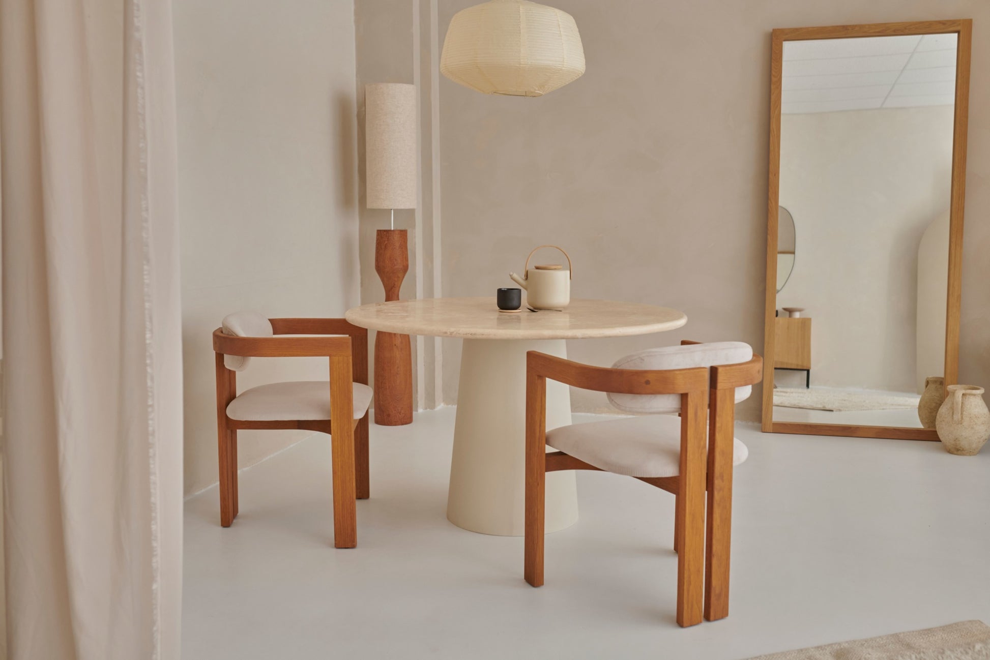 Aime Té Tribute dining chair with upholstered off-white seat and black legs, modern design and comfortable seating.