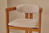 Aime Té Tribute dining chair with upholstered off-white seat and black frame, modern and stylish for contemporary dining rooms.