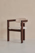 Aime Té Tribute dining chair with black frame and off-white upholstered seat, modern design, photographed from side angle.