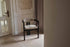 Aime Té Tribute dining chair with upholstered off-white seat and black frame, modern design perfect for dining rooms.