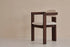Aime Té Tribute dining chair with black frame and off-white upholstered seat, modern design with sleek lines.