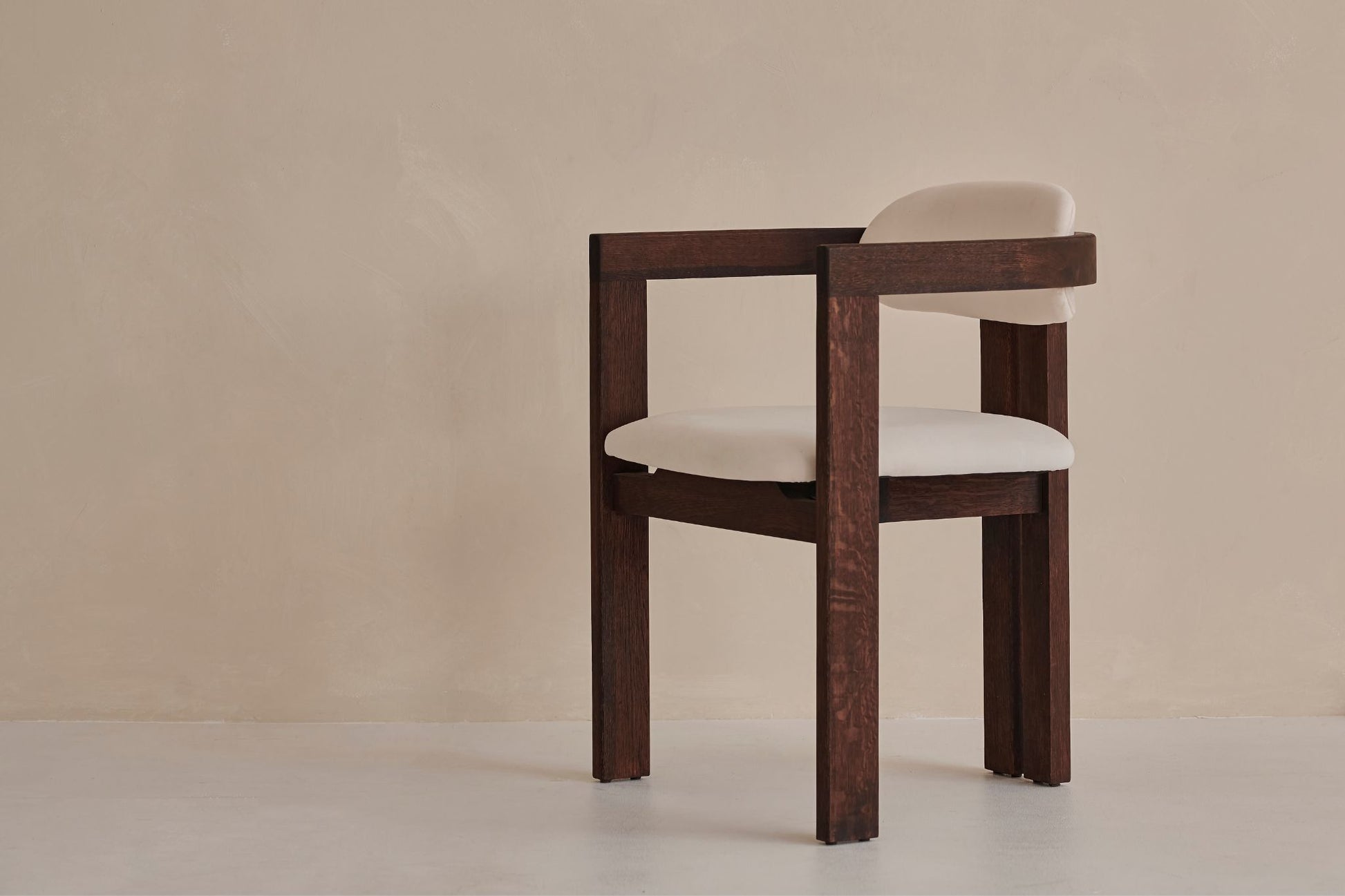 Aime Té Tribute dining chair with black frame and off-white upholstered seat, modern design with sleek lines.