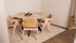 Glossy round marble dining table with Crema Marfil beige marble top and arch-shaped base by Aime Té.