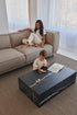 Marble block coffee table in Nero Marquina black with matte finish, rectangular shape, and modern design.