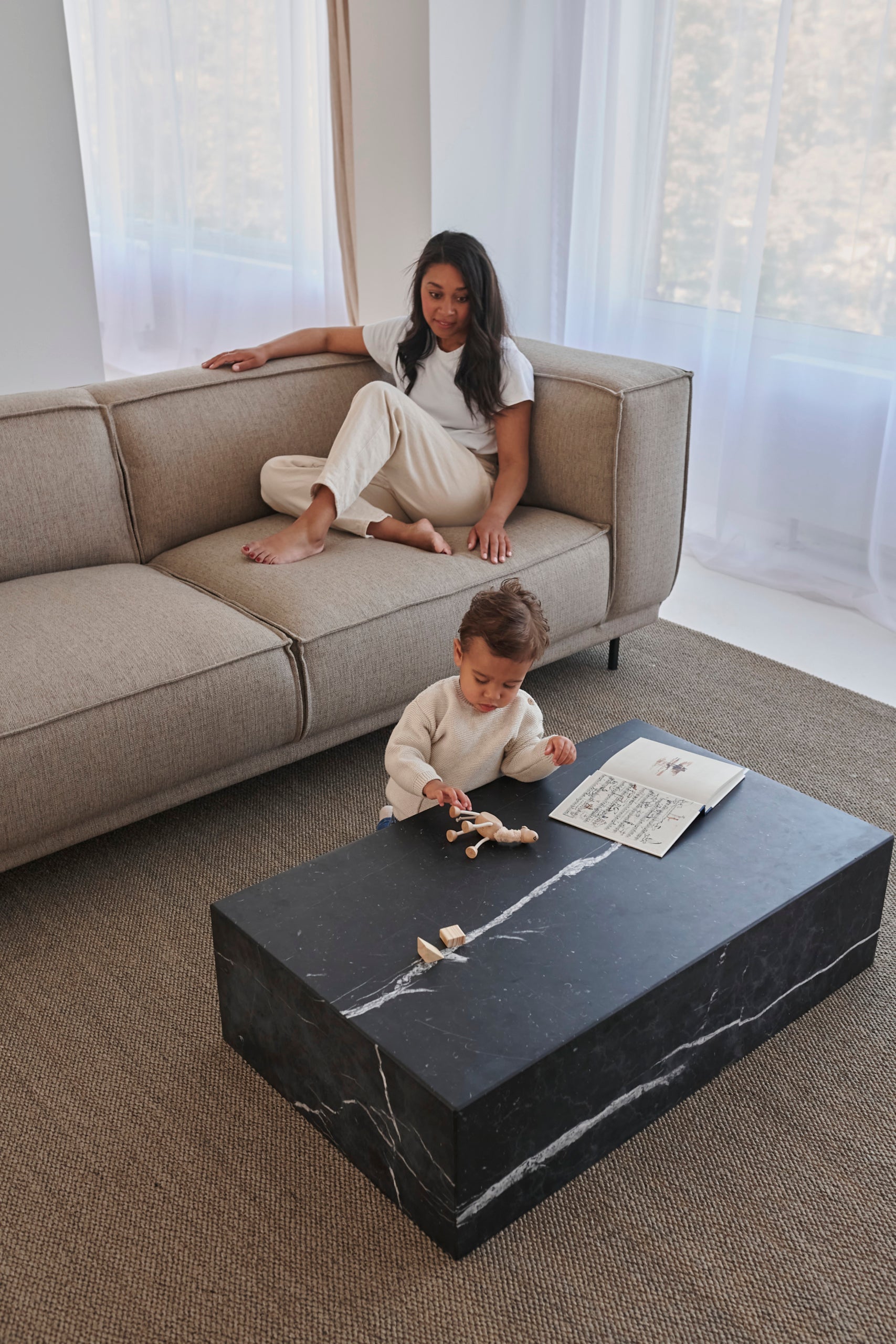 Marble block coffee table in Nero Marquina black with matte finish, rectangular shape, and modern design.