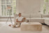 Travertine block coffee table with a rectangular shape, featuring a natural stone surface and sturdy base in a modern living room setting.