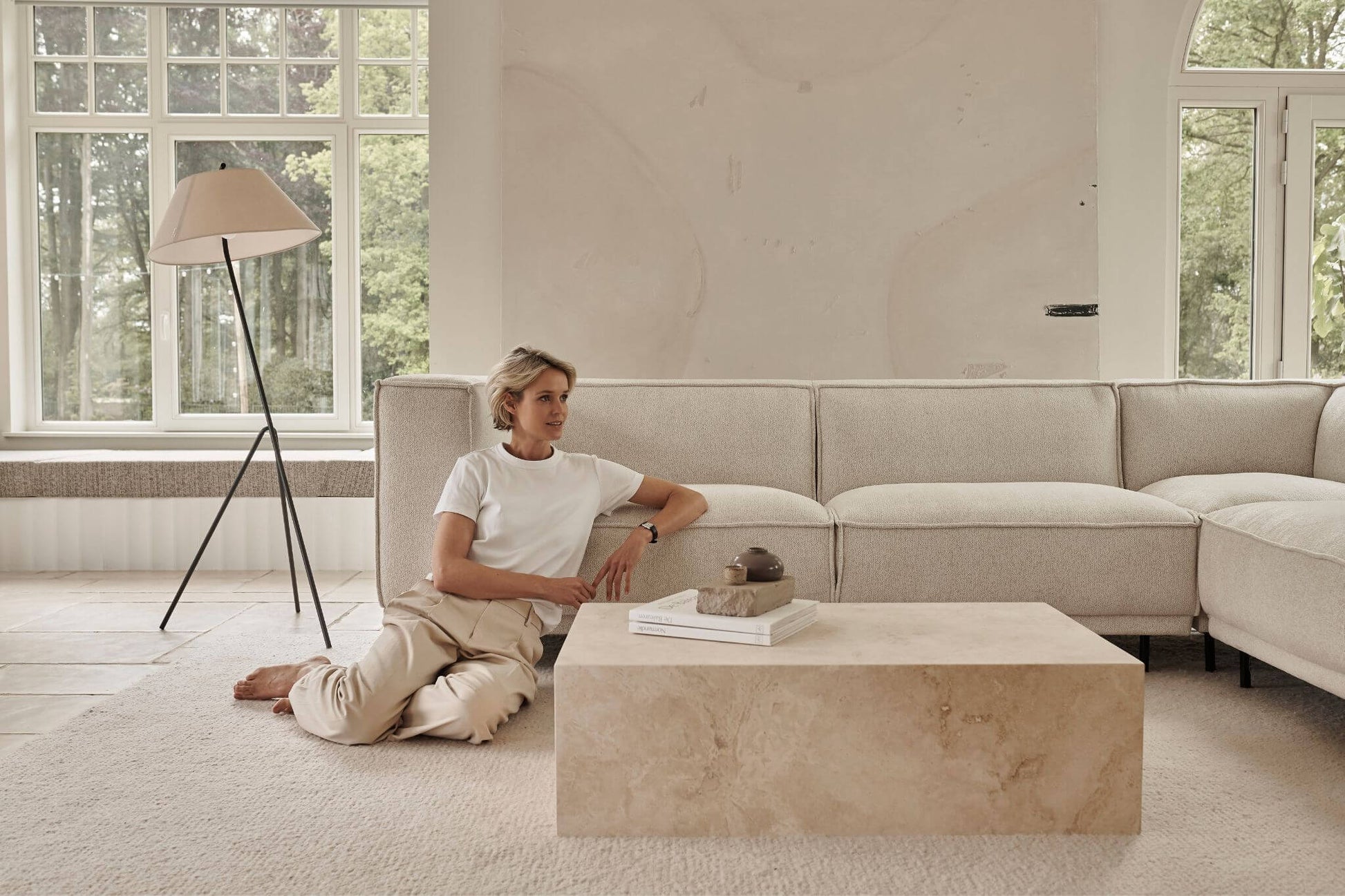 Travertine block coffee table with a rectangular shape, featuring a natural stone surface and sturdy base in a modern living room setting.