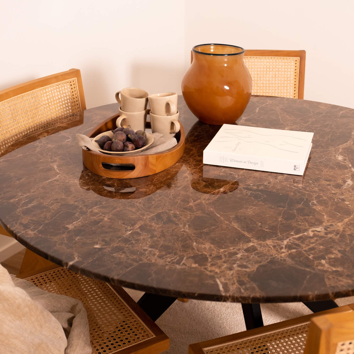 Round marble dining table with dark Emperador brown marble top and arch-style wooden legs, modern and elegant design.