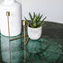 Round India Green marble dining table with arch-shaped metal legs, modern design, ideal for contemporary dining spaces.