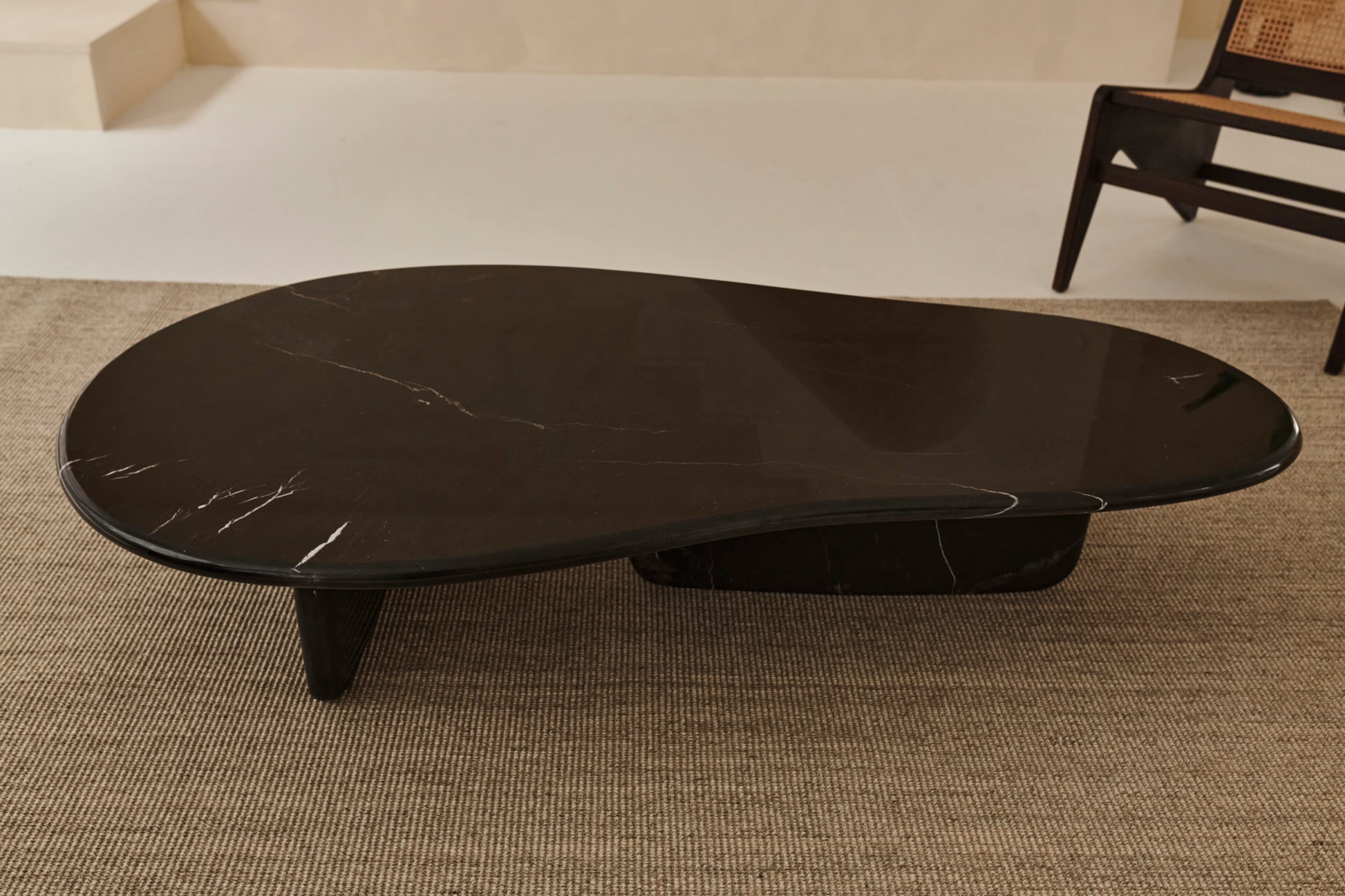 Black Nero Marquina marble FORM coffee table with sleek rectangular design in a modern living space.