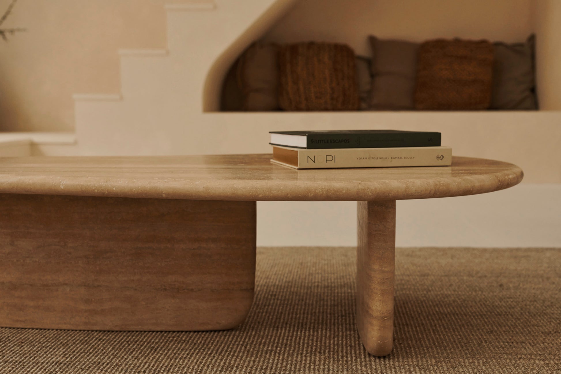 Form coffee table made of travertine with sleek, rectangular design and natural stone surface.