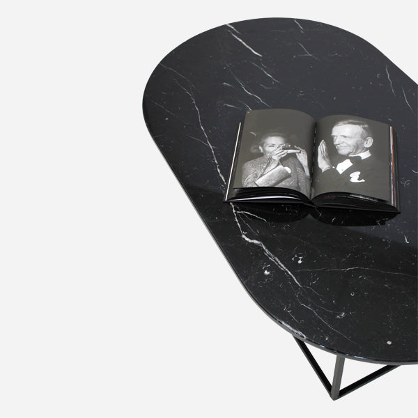 Glossy oval marble coffee table in Nero Marquina black with sleek design, featuring a smooth marble surface and modern style.