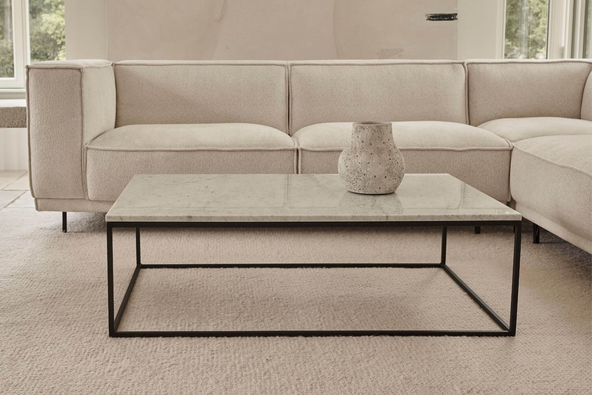 Rectangular marble coffee table with travertine surface and wooden legs, modern design for living room decor.