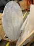 Round KIYO dining table with Bianco Carrara white marble top, showing a small dent and glue residue on the side.