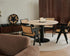 KIYO round dining table with Travertine surface and black center-leg, slight side damage, and small stains visible in the image.