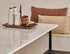 Rectangular marble dining table with glossy Bianco Carrara White surface and U-shaped metal frame for elegant dining space.