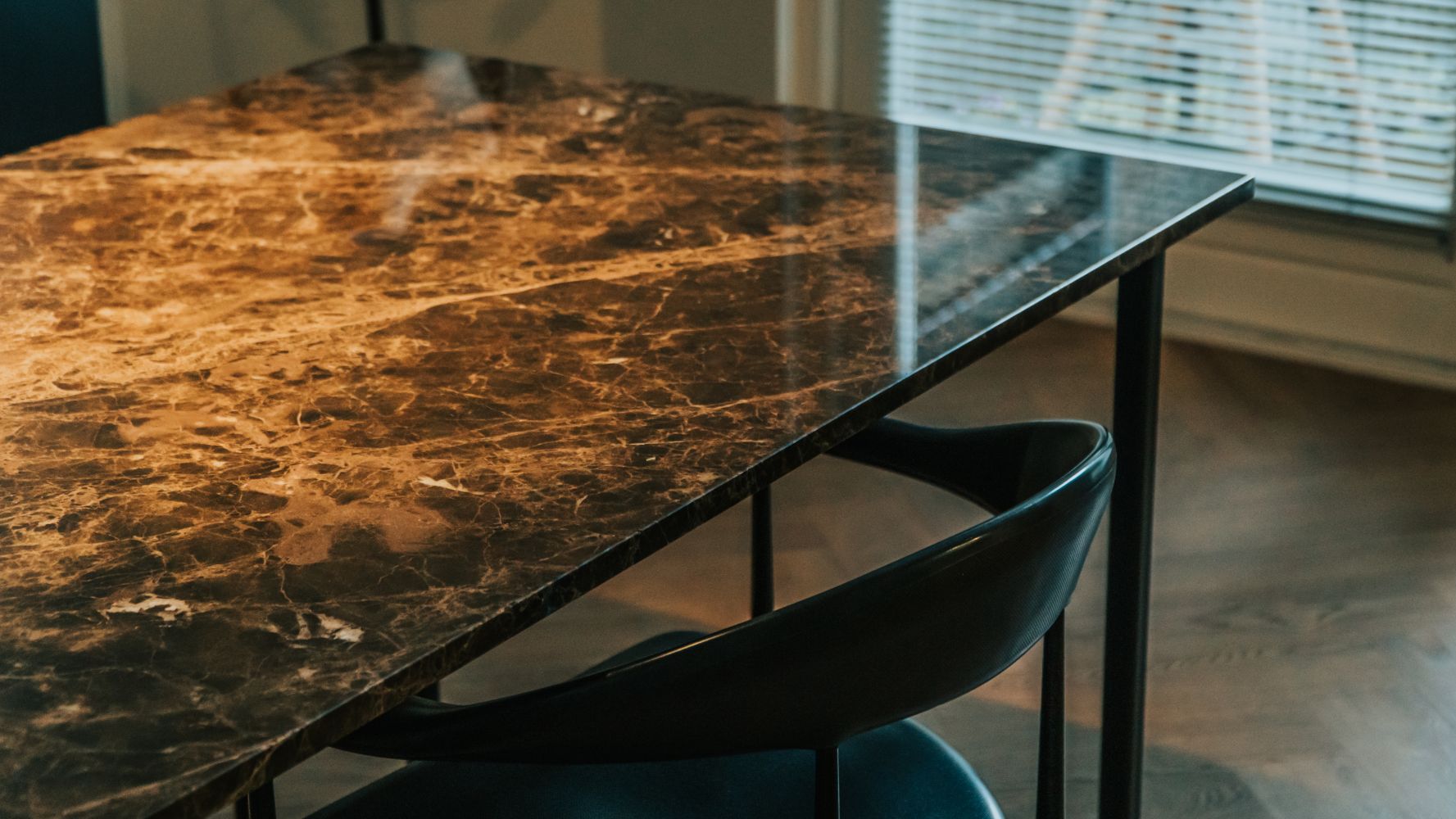 Dark Emperador brown rectangular marble dining table with glossy finish and U-frame design, ideal for modern dining spaces.
