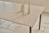 Glossy rectangular marble dining table in Crema Altea with four legs, ideal for modern dining spaces.