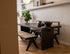 Rectangular dining table in natural oak wood with a modern design, featuring a sturdy tabletop and sleek legs.