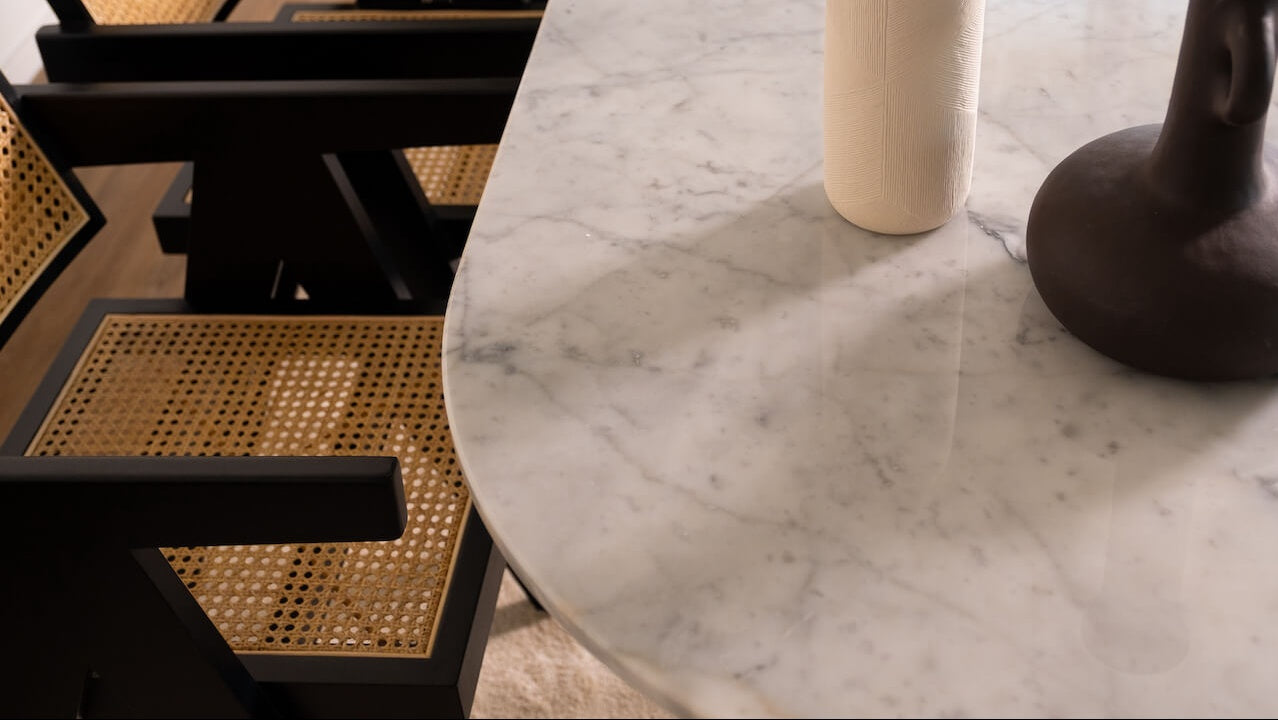 Half oval marble dining table with glossy Bianco Carrara white surface and V-frame base, perfect for modern dining spaces.