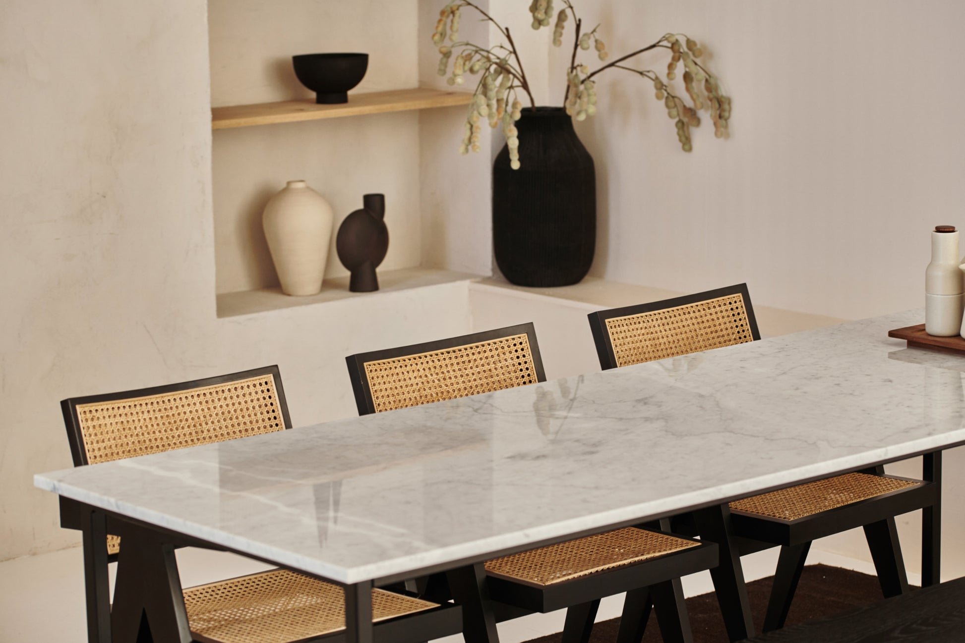 Rectangular Bianco Carrara white marble dining table with four legs, matte dent in the middle, ideal for modern dining rooms