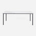 Rectangular marble dining table with four legs in Bianco Carrara white with matte finish and dent detail in the center.