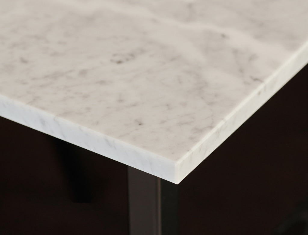 Rectangular Bianco Carrara White marble dining table with four legs, matte finish, dent in the middle, designed for modern dining spaces
