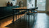 Rectangular marble dining table with dark Emperador brown finish, glossy surface, four-legged design, ideal for modern dining rooms