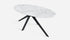 Oval marble dining table with Bianco Carrara white marble surface and arch metal frame, modern and glossy design.