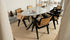 Glossy oval marble dining table with Bianco Carrara white surface and arch-style base, ideal for modern dining rooms.