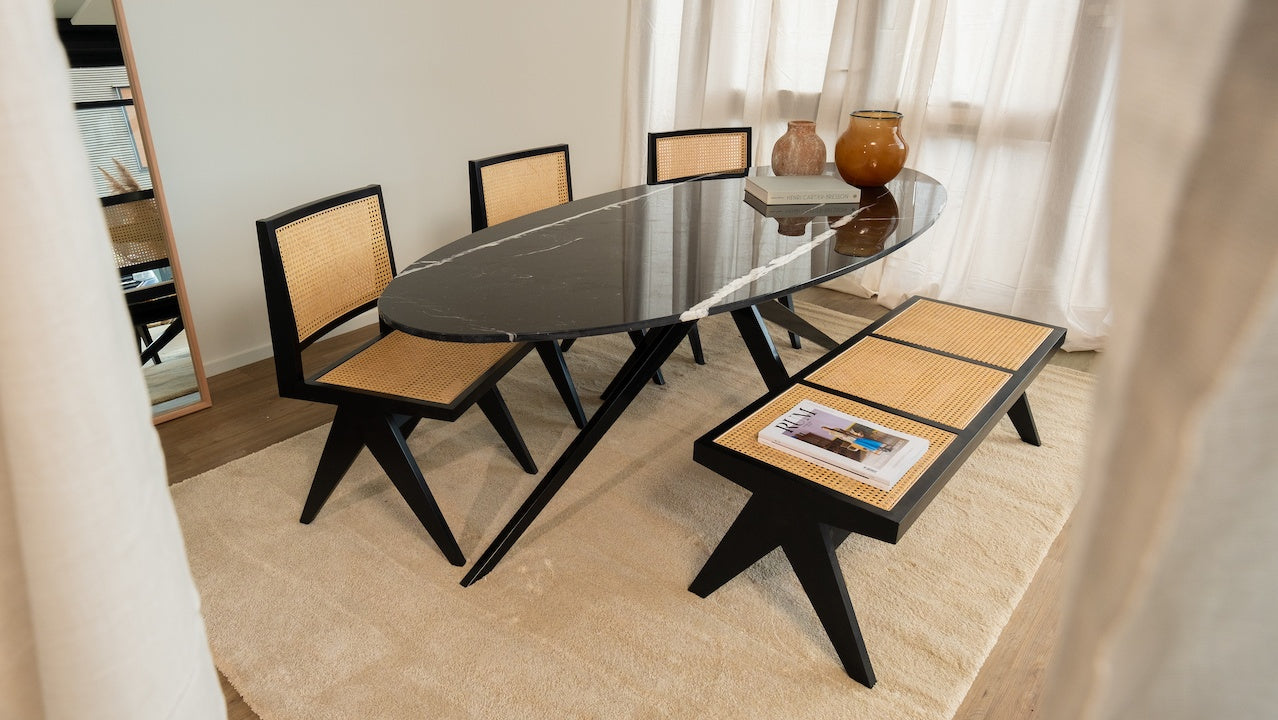 Glossy oval Nero Marquina marble dining table with arch black metal frame, stylish and modern for contemporary dining rooms.
