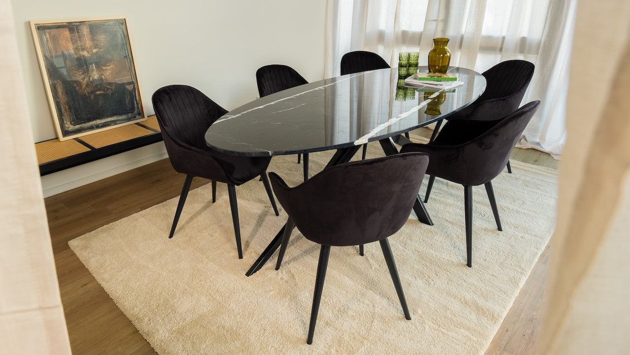 Black Nero Marquina marble oval dining table with an arch metal frame, glossy finish, ideal for modern dining spaces.