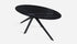 Glossy Nero Marquina black oval marble dining table with arch-shaped base, ideal for modern dining rooms.