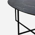 Glossy oval marble dining table with Nero Marquina black marble top and cross-frame base, ideal for modern dining rooms.