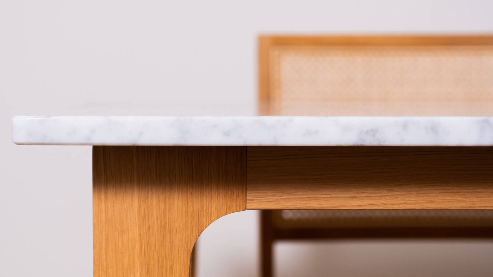 Rectangular marble dining table with Bianco Carrara white surface and wooden frame, glossy finish, perfect for modern dining rooms.