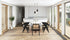 Oval marble dining table with Bianco Carrara white surface and cross-frame design, matte grey tint with small scratches.
