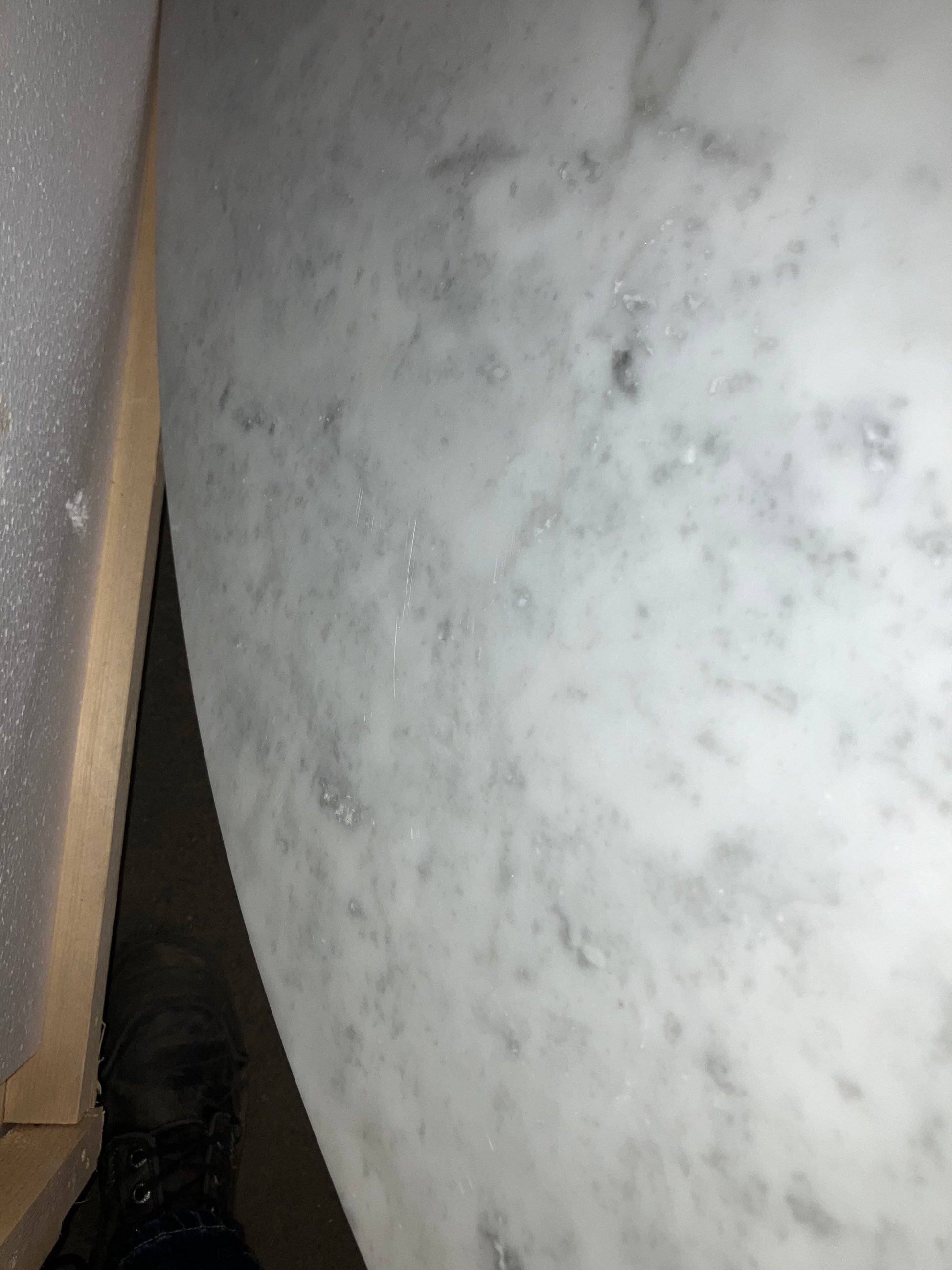 Oval Bianco Carrara marble dining table with cross-frame, matte grey tint, small scratches, 160x100cm, from My Store.
