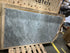 Rectangular Bianco Carrara white marble dining table with four legs, matte finish, slight gray discoloration, minor edge damage.