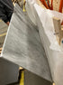 Rectangular Bianco Carrara white marble dining table with four legs, matte grey tint and small dent, 180x100 cm.