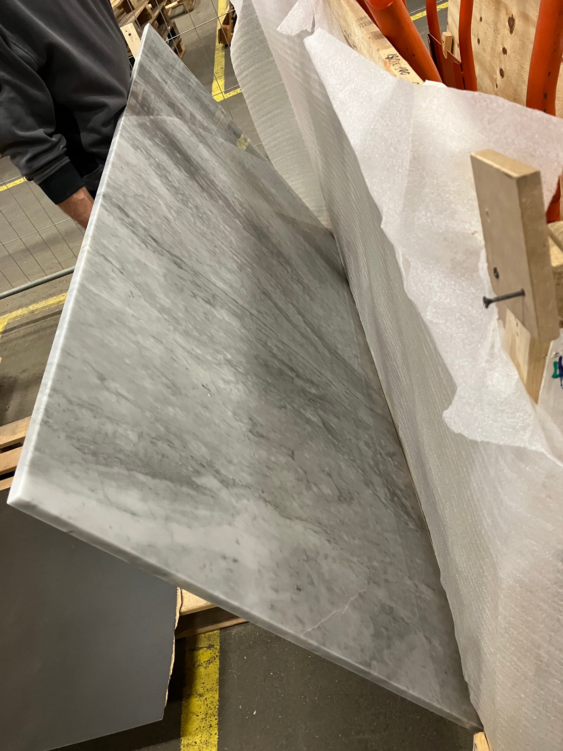 Rectangular Bianco Carrara white marble dining table with four legs, matte grey tint and small dent, 180x100 cm.