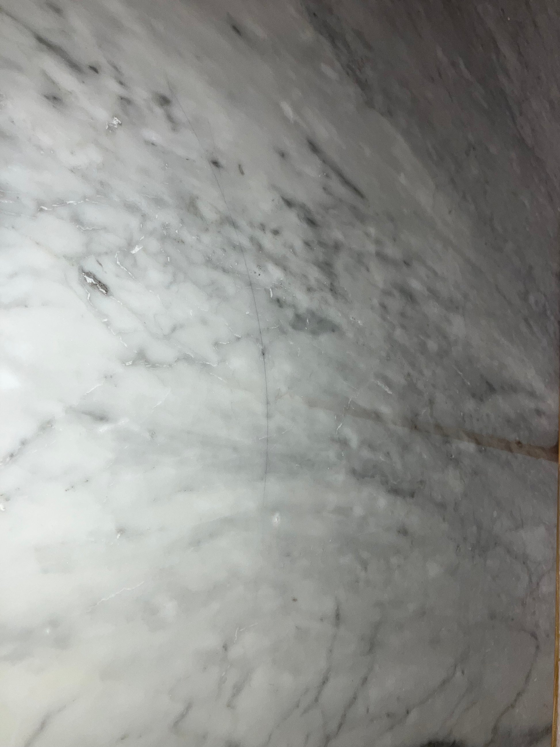 Rectangular marble dining table in Bianco Carrara White with black veining, four-legged design, matte grey tint, 180x80 cm.