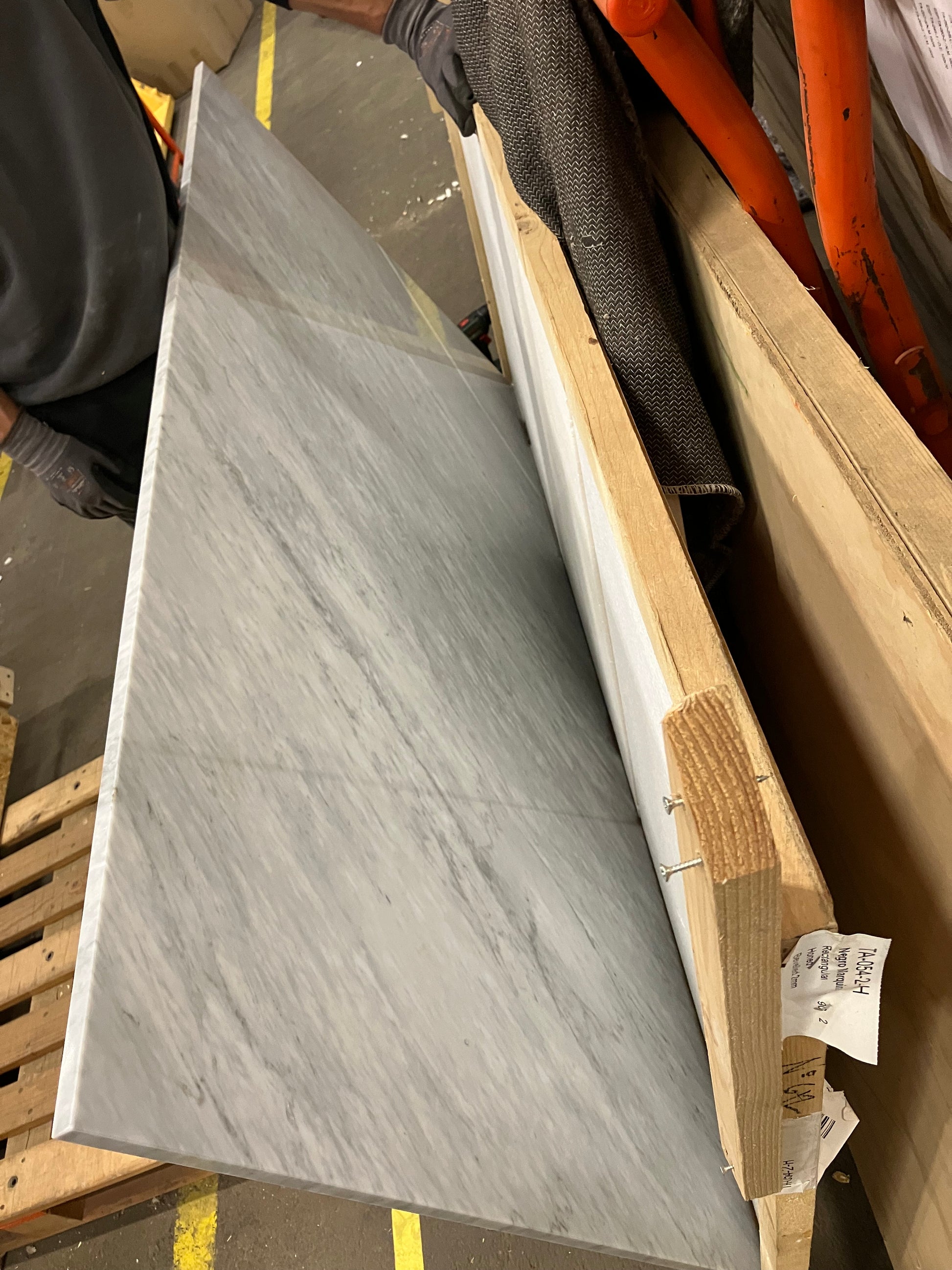 Rectangular marble dining table with white Bianco Carrara finish, four-legged design, matte surface, small edge dent, 180x90 cm.