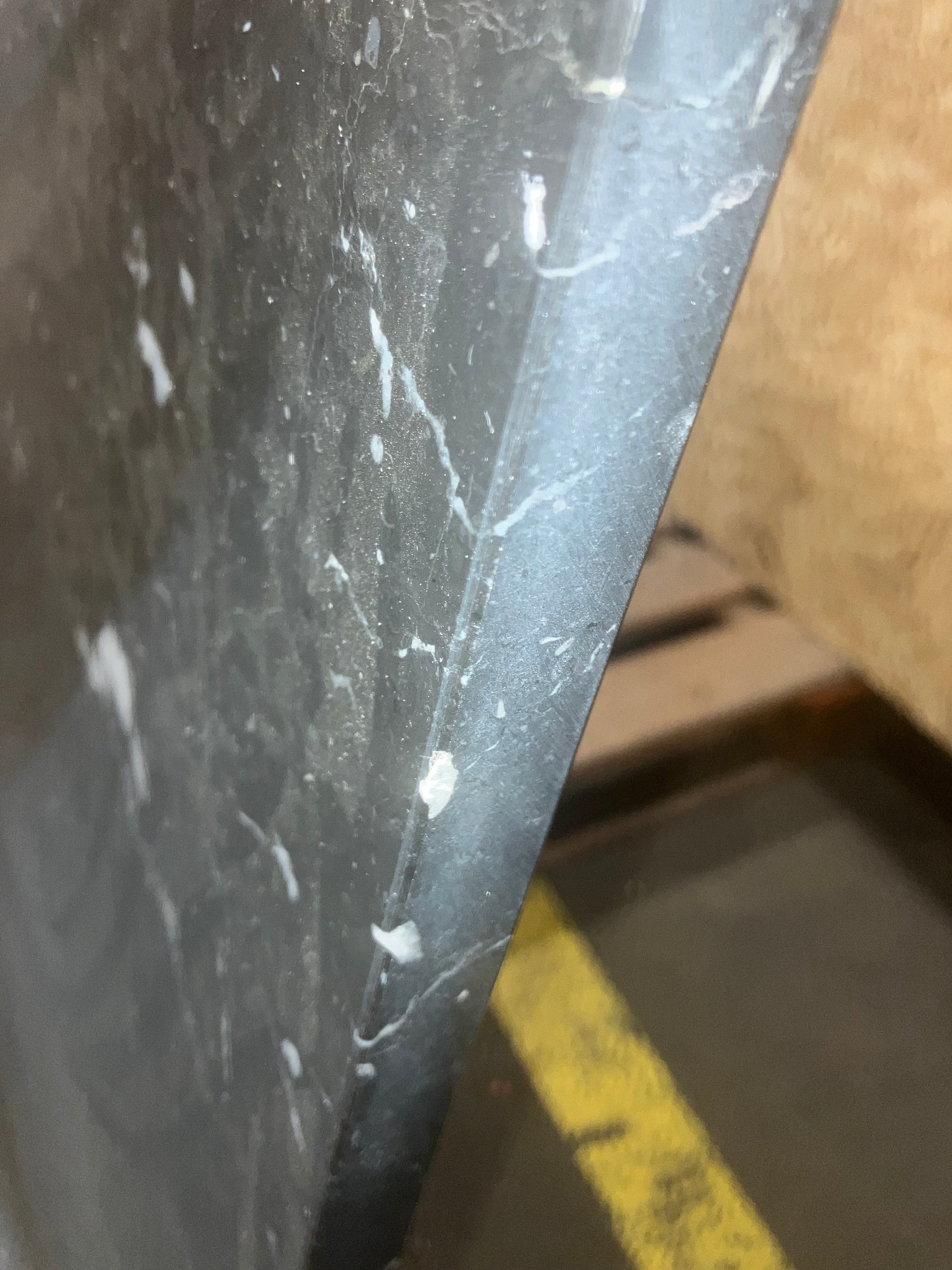 Rectangular Nero Marquina black marble dining table with U-frame, matte finish, small dents, and stains, measuring 200x90 cm.