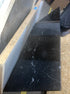 Rectangular Nero Marquina black marble dining table with U-frame, matte finish, small side dents, and stains, measuring 200x90 cm.