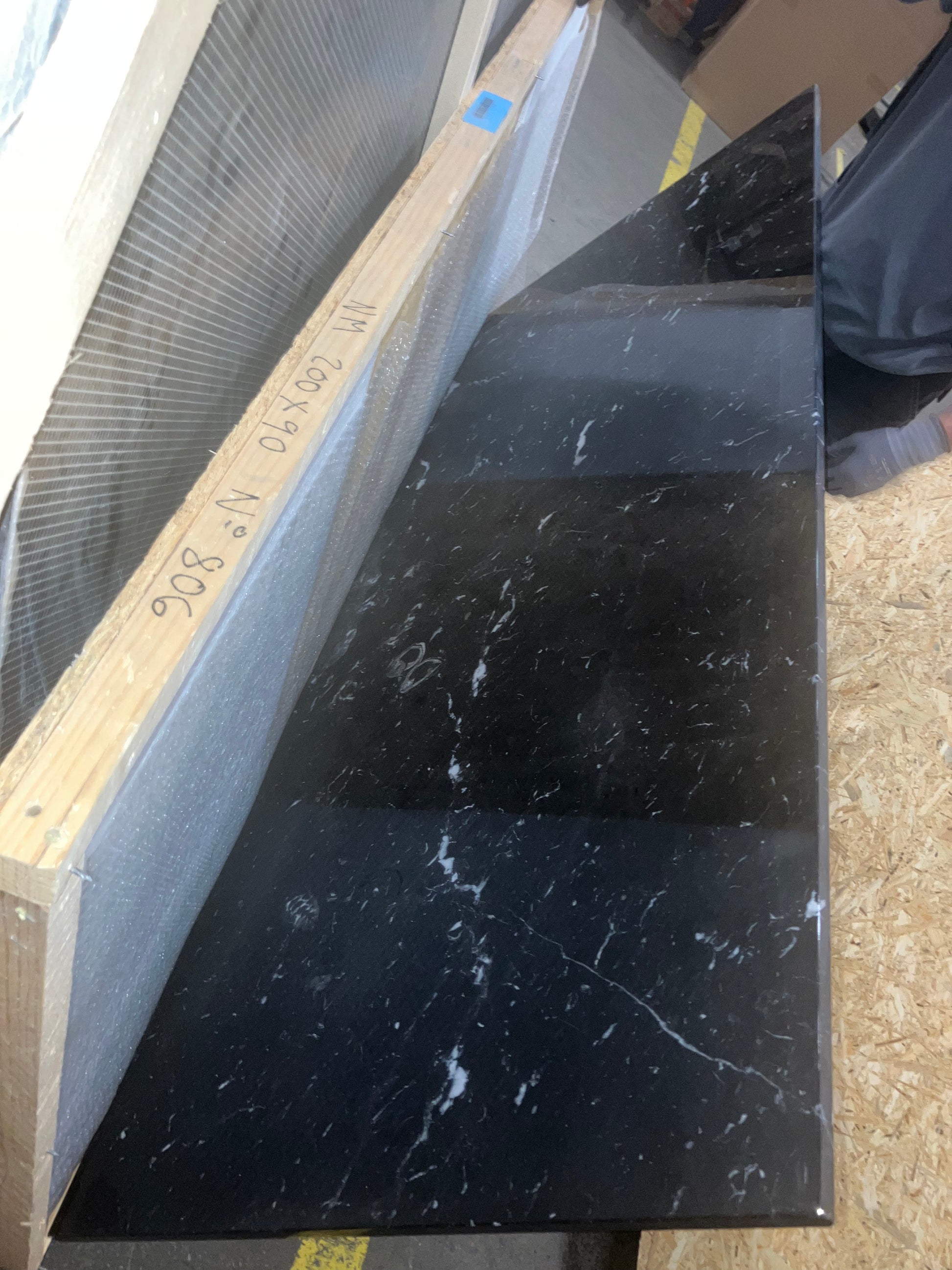 Rectangular Nero Marquina black marble dining table with U-frame, matte finish, small side dents, and stains, measuring 200x90 cm.