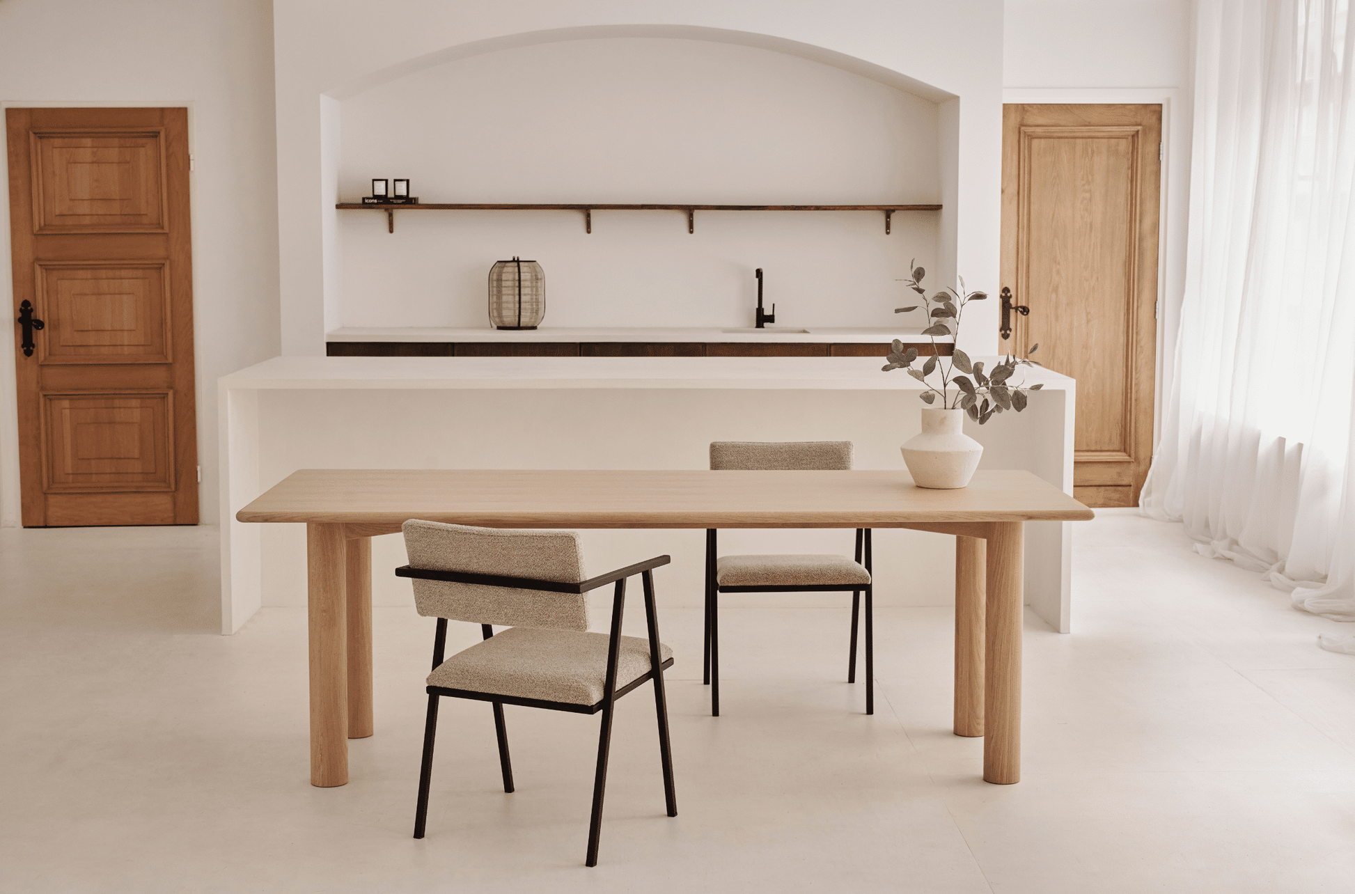 Rectangular dining table in natural oak with a sleek, minimalist design, perfect for modern dining rooms.
