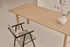 Rectangular dining table in natural oak wood with a sleek design, perfect for modern dining rooms.
