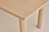 Rectangular dining table in natural oak wood with a sleek design, perfect for dining rooms.