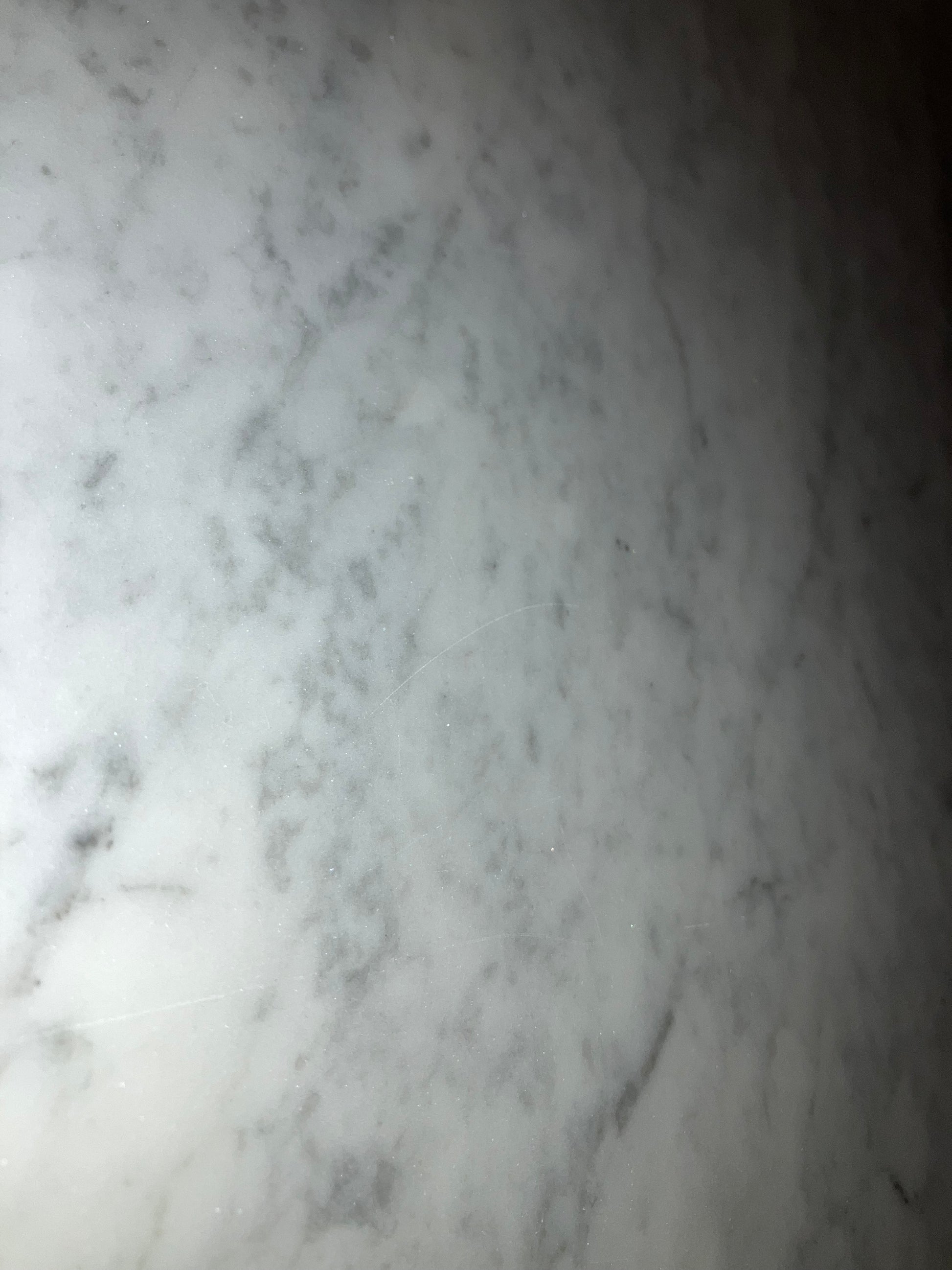 Rectangular marble dining table with four legs in Bianco Carrara White, glossy finish with minor scratches, 220x100 cm.